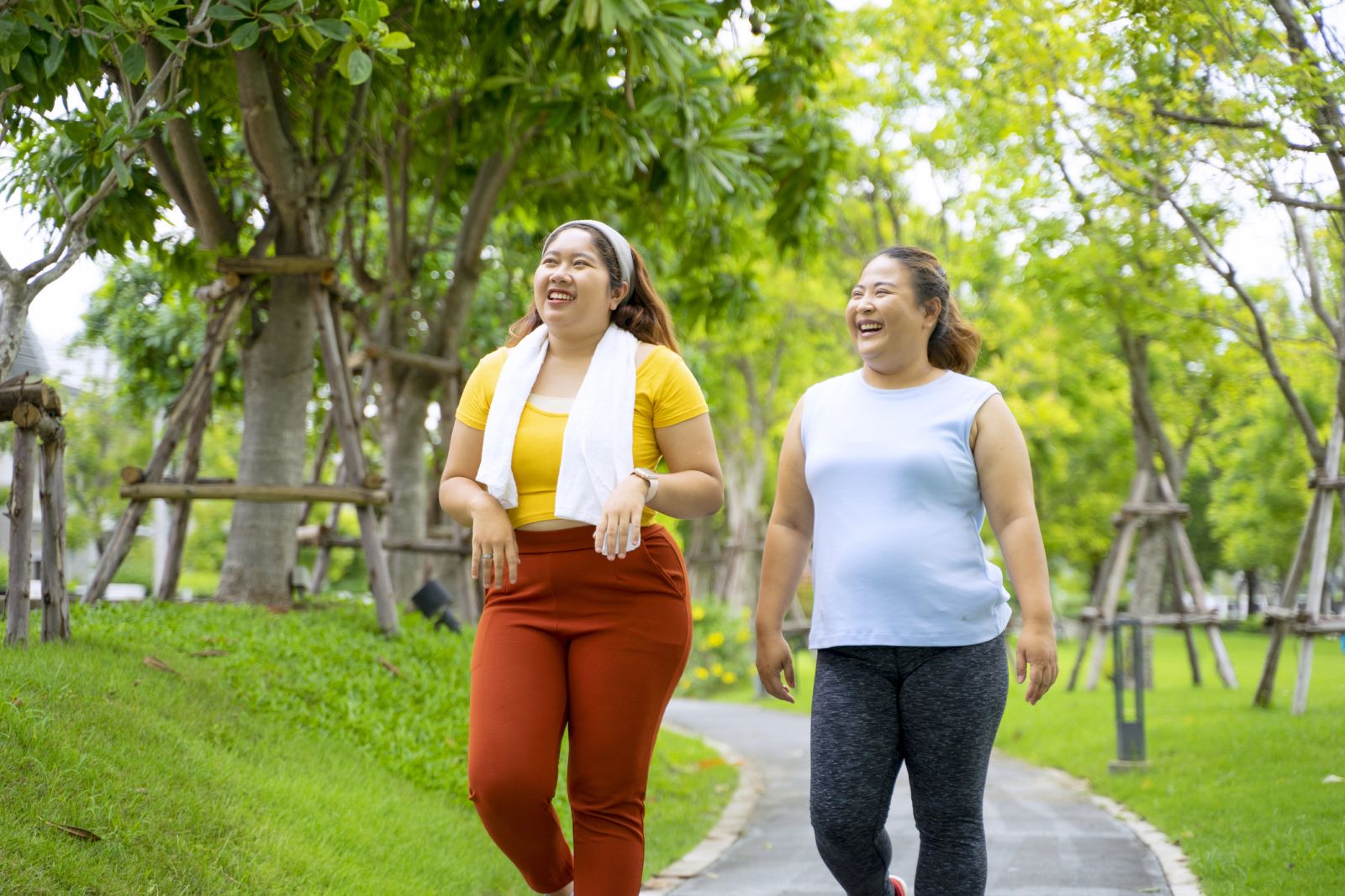 Two people with obesity take a walk in the park