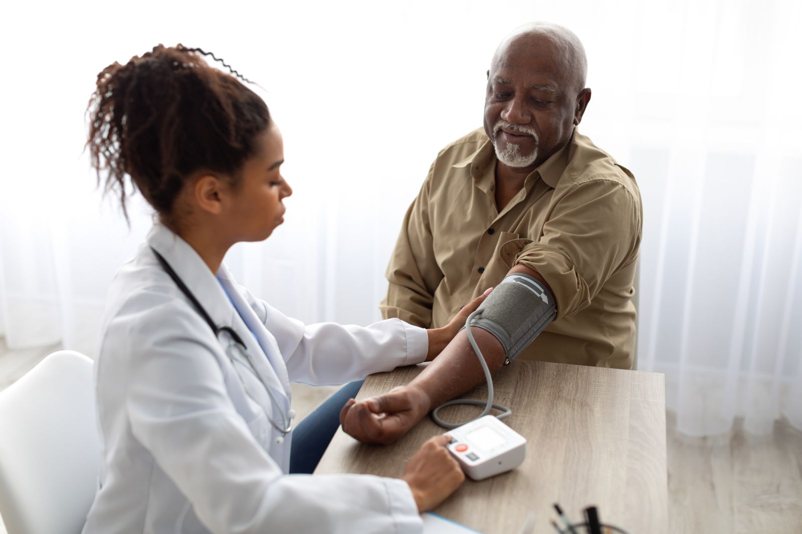 A person with diabetes receives a blood pressure screening