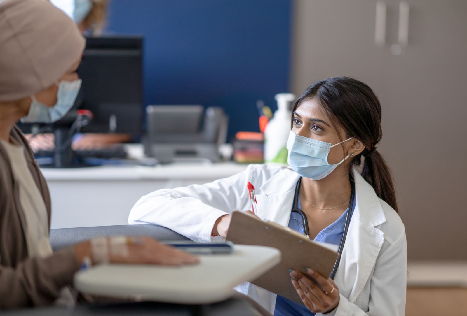 A researcher discusses a clinical trial with a patient