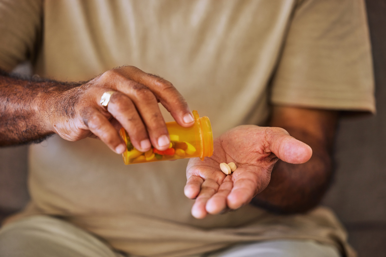 An older person takes their medication