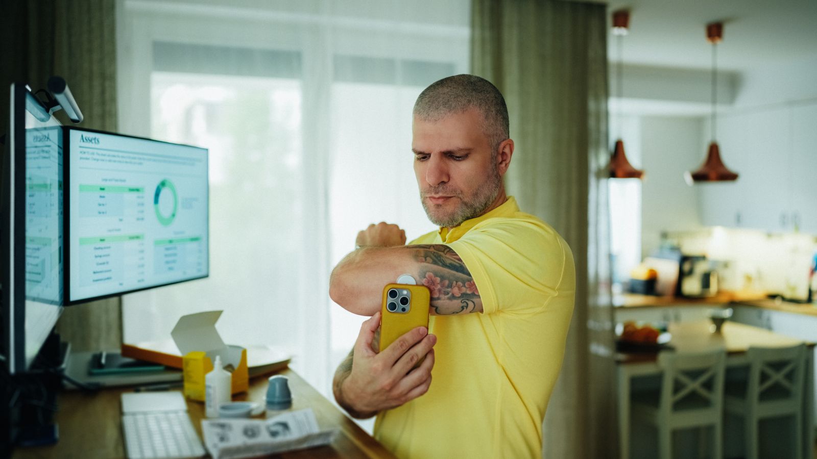 A person with diabetes checks his blood glucose using a CGM