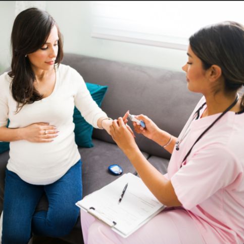 Pregnant woman testing blood glucose levels