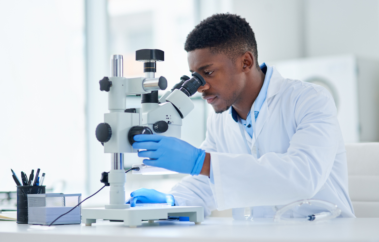 Scientist looking through microscope