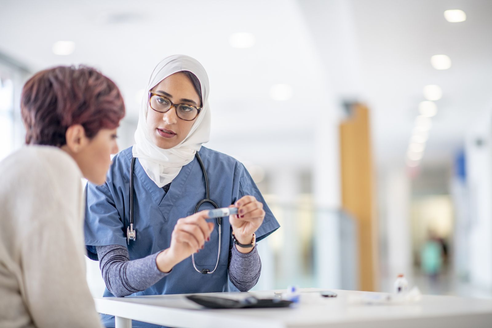 Doctor explaining insulin pen to patient