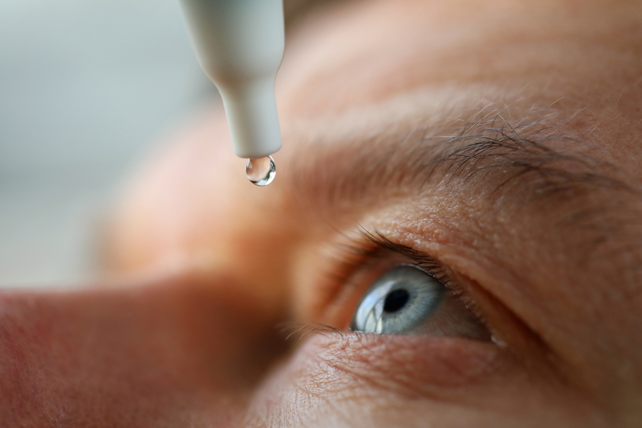 Man putting in eyedrops