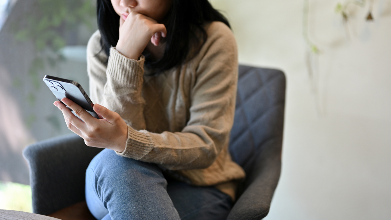 A woman uses an app on her phone