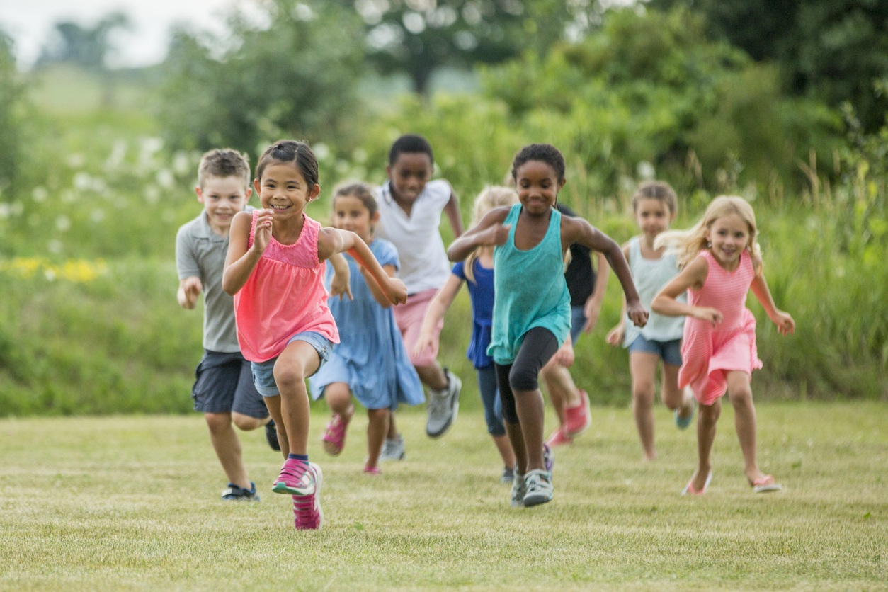 A group of children running outside