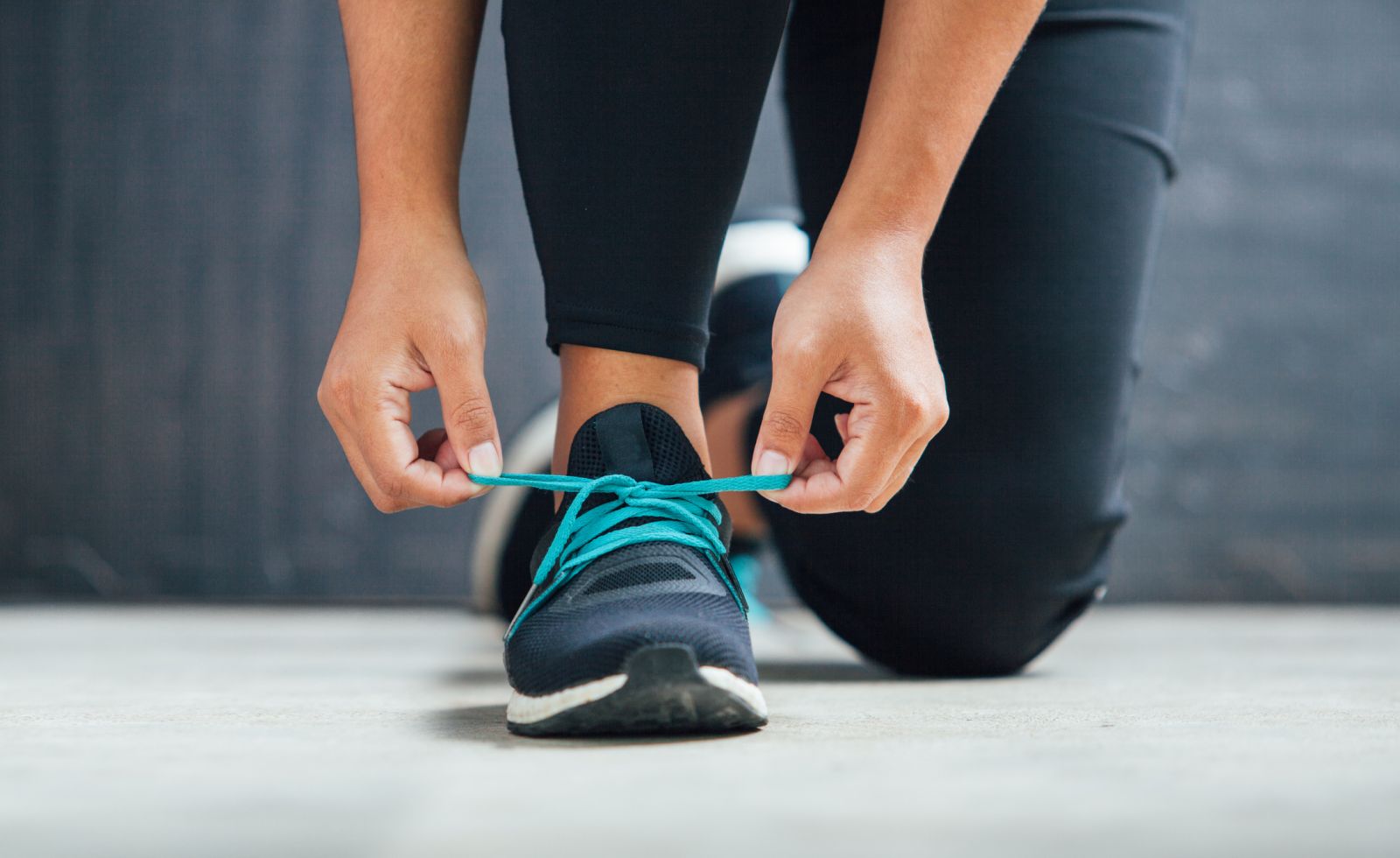 Person lacing up running shoe