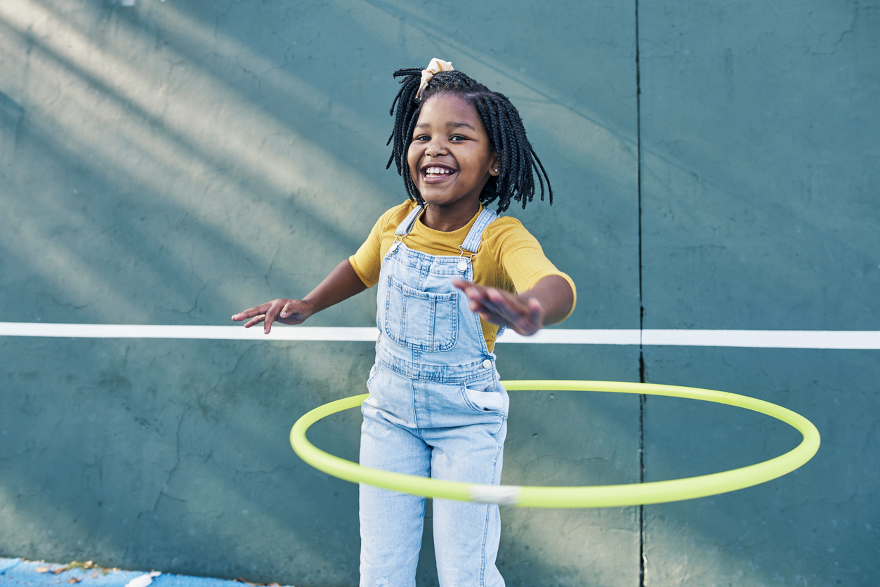 A girl hula hoops for exercise