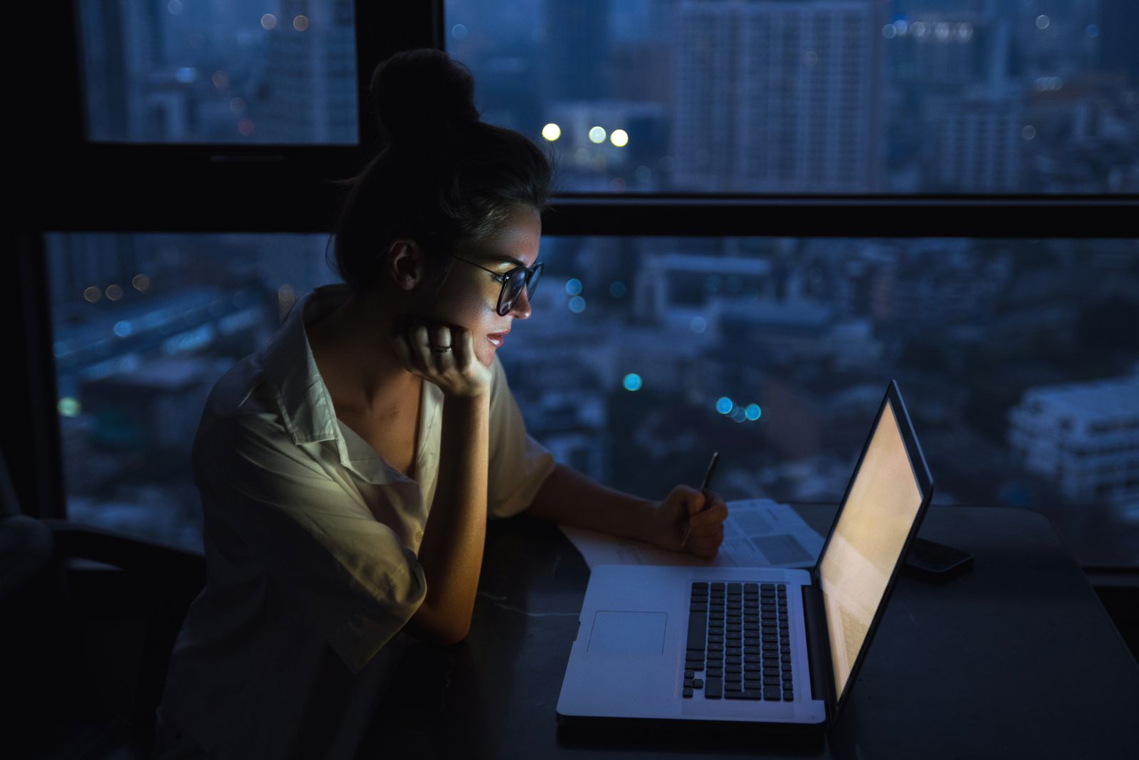 A person working the night shift by her laptop