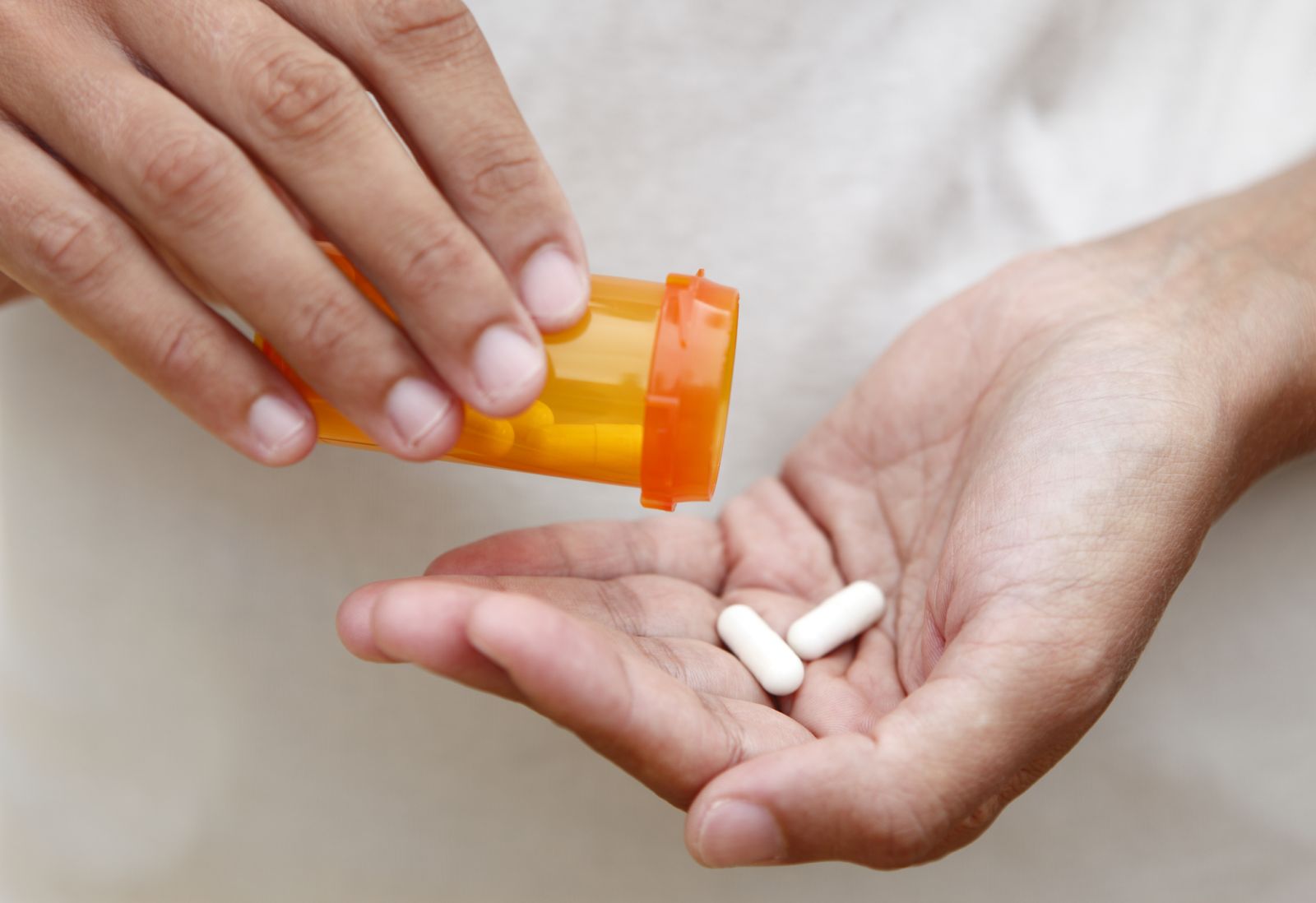 A person with diabetes opens a medicine bottle