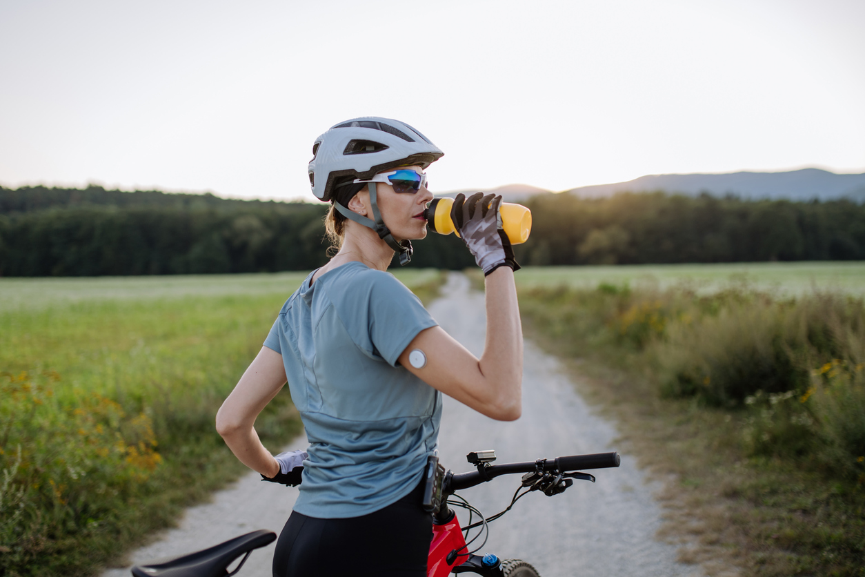 A person with diabetes uses CGM while biking to manager her blood sugar