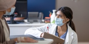 A researcher discusses a clinical trial with a patient