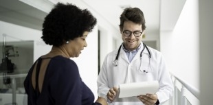 A woman consults her healthcare provider about participating in a clinical trial