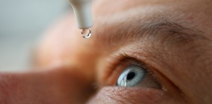 Man putting in eyedrops