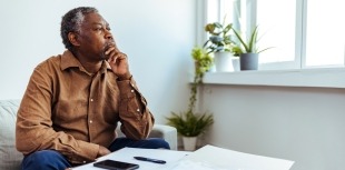 Man looking out window