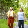 Two people with obesity take a walk in the park