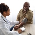 A person with diabetes receives a blood pressure screening