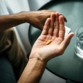 A person holds a pill