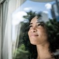 Woman looking out window