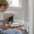 girl using insulin pump checks blood sugar