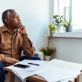 Man looking out window