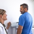 doctor weighing patient