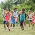 A group of children running outside